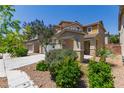 A beautiful two-story home with a two car garage, landscaped yard, and walkway at 104 Big Cliff Ave, North Las Vegas, NV 89031