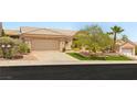 Charming single-story home with a well-manicured lawn and mature trees enhancing its curb appeal at 10404 Long Leaf Pl, Las Vegas, NV 89134