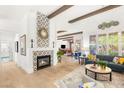Inviting living room boasts a tiled fireplace, hardwood floors, and an open floor plan at 10404 Long Leaf Pl, Las Vegas, NV 89134