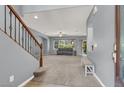Spacious foyer with staircase and open view to the living room, creating a welcoming entrance at 10845 Drake Ridge Ave, Las Vegas, NV 89166