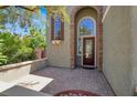 Inviting front porch with brick flooring and a decorative front door with sidelight windows at 10845 Drake Ridge Ave, Las Vegas, NV 89166