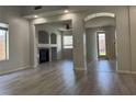 Open concept living space featuring new laminate floors and archways at 11029 Meadow Leaf Ave, Las Vegas, NV 89144