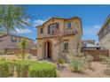 Exterior shot of the home highlighting the lush landscaping, arched entryway and earth tone stucco exterior at 1130 Blissful Plains Ave, North Las Vegas, NV 89086