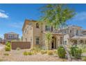 View of the home highlighting the attractive earth tone stucco, brick accents, and low maintenance landscaping at 1130 Blissful Plains Ave, North Las Vegas, NV 89086