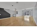 Bright, open living space with hardwood floors, a modern light fixture, and sliding doors leading to outdoor space at 1190 E Carson Ave, Las Vegas, NV 89101