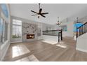 Open concept living room with modern fireplace and staircase at 1611 Buffalo Trail Dr, Henderson, NV 89014