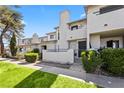 Charming townhouse with a private courtyard, lush lawn, and mature trees creating curb appeal at 1628 Justin Ct # 18, Henderson, NV 89011