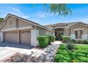 Lovely home with a tile roof, manicured bushes, grassy lawn and charming front walkway at 1763 Crystal Stream Ave, Henderson, NV 89012