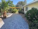 Inviting paver driveway with mature landscaping, creating a serene pathway to the home's entrance at 1819 Beverly Way, Las Vegas, NV 89104