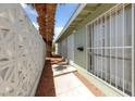Side view of home featuring decorative breeze block and security bars at 1828 Golden Arrow Dr, Las Vegas, NV 89169