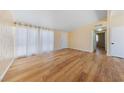 Bright living room with wood-look floors, neutral walls and ample natural light at 1828 Golden Arrow Dr, Las Vegas, NV 89169