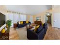 Staged living room featuring contemporary furnishings and ample natural light at 1828 Golden Arrow Dr, Las Vegas, NV 89169