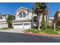 Beautiful two-story home featuring a three-car garage, manicured lawn and mature palm trees against a brilliant blue sky at 2090 Eaglepath Cir, Henderson, NV 89074