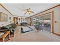 Bright living room featuring plush seating, a ceiling fan, and access to the covered patio at 22 Jade Cir, Las Vegas, NV 89106