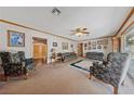 Spacious living room with comfortable seating, a ceiling fan, and wood trim details at 22 Jade Cir, Las Vegas, NV 89106