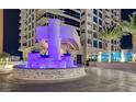 Close up of a condo building entrance with a cascading water feature and colorful accent lighting at 2700 Las Vegas Blvd # 610, Las Vegas, NV 89109