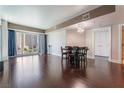 Spacious living room with hardwood floors, modern light fixture, and a large window with city views at 2700 Las Vegas Blvd # 610, Las Vegas, NV 89109