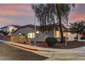 Corner lot home featuring desert landscaping, privacy fence, and a tile roof at twilight at 2725 Cool Lilac Ave, Henderson, NV 89052