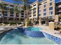 Inviting in-ground pool with attached spa area with blue tile detailing in an upscale condo complex at 29 Montelago Blvd # 336, Henderson, NV 89011