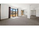 Bright, open living room with a wall of windows offering scenic views and a seamless transition to a dining area at 29 Montelago Blvd # 520, Henderson, NV 89011