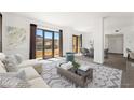 Bright living room featuring large windows with scenic views, stylish furnishings, and open floorplan connecting dining area at 29 Montelago Blvd # 520, Henderson, NV 89011