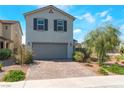 Inviting two-story home with a tidy front yard, a brick driveway, and a two-car garage at 2935 Saltillo Ln, Las Vegas, NV 89121