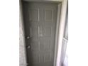 The front door to the home is a grey color, and it has a gold number on the door for the unit number at 2981 Country Manor Ln # 118, Las Vegas, NV 89115