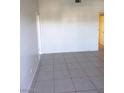 The Living room in this home has grey tile floors and white walls, with an open doorway into another room at 2981 Country Manor Ln # 118, Las Vegas, NV 89115