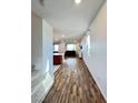 Open concept living space with wood-look flooring and natural light at 438 Wind Poppy St, Las Vegas, NV 89138