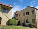 Condo building with red tiled roof and well maintained landscaping at 4720 Obannon Dr # D, Las Vegas, NV 89102