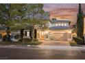 Charming home exterior showcases a manicured lawn, paved driveway, and a secure gated entry for added privacy at 516 Pinnacle Heights Ln, Las Vegas, NV 89144