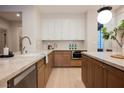Modern kitchen features a tiled backsplash, stainless steel appliances, and marble countertops at 516 Pinnacle Heights Ln, Las Vegas, NV 89144