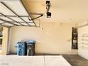 Well-lit two-car garage with storage shelves and utility connections at 5653 Mount Athos St, North Las Vegas, NV 89031