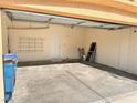 Large two-car garage featuring overhead storage and access door at 5653 Mount Athos St, North Las Vegas, NV 89031