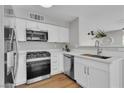 Modern kitchen with white cabinets, stainless steel appliances, and quartz countertops at 5710 E Tropicana Ave # 2152, Las Vegas, NV 89122