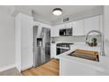 Well-equipped kitchen with stainless steel appliances, white cabinetry, and elegant quartz countertops and flooring at 5710 E Tropicana Ave # 2152, Las Vegas, NV 89122