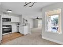 Open-concept kitchen with white cabinets flows into the living area with a large window at 5710 E Tropicana Ave # 2152, Las Vegas, NV 89122
