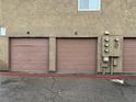 Exterior image showcasing assigned garages, each with a separate door and assigned number at 574 Roxella Ln # C, Las Vegas, NV 89110