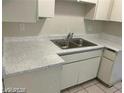 A close up view of a double sink in a kitchen with white countertops at 615 S Royal Crest Cir # 10, Las Vegas, NV 89169