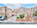 Inviting home featuring a manicured front yard with mature landscaping and a paved driveway at 6233 Overhang Ave, Henderson, NV 89011