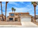 Inviting two-story home featuring a neutral color scheme and large front yard at 7004 Powderhorn Cir, Las Vegas, NV 89128