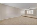 Open-concept living room with plush carpeting and ample natural light at 7004 Powderhorn Cir, Las Vegas, NV 89128