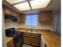 Functional kitchen featuring wood countertops and essential appliances at 854 Stainglass Ln, Las Vegas, NV 89110