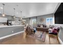 Open-concept living and kitchen area with modern finishes, hardwood floors, stylish furniture, and natural light at 855 N Stephanie St # 2121, Henderson, NV 89014