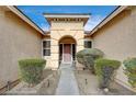 Inviting home entrance with desert landscaping, decorative pillars, and a covered entryway at 9092 National Park Dr, Las Vegas, NV 89178
