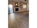 Spacious living area with wood flooring, stone accent wall, and a cozy fireplace at , Henderson, NV 89002