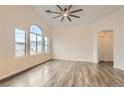 Spacious, open living area with vaulted ceilings, large windows, and modern wood-look flooring at 10147 Aspen Rose St # 101, Las Vegas, NV 89183