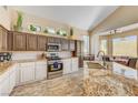 Bright kitchen boasts granite countertops, stainless appliances, and an adjacent breakfast nook at 1028 Dodger Blue Ave, Las Vegas, NV 89123
