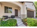 Inviting front porch with comfortable seating and stylish lighting fixtures at 10353 Yew Blossom Ave, Las Vegas, NV 89166