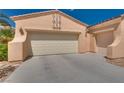 Spacious two car garage with ample parking space and desert landscaping at 10361 Profeta Ct, Las Vegas, NV 89135